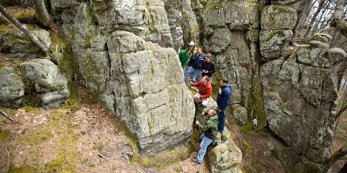 students study a rock formation
