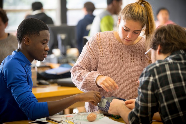 students work on a physics experiment