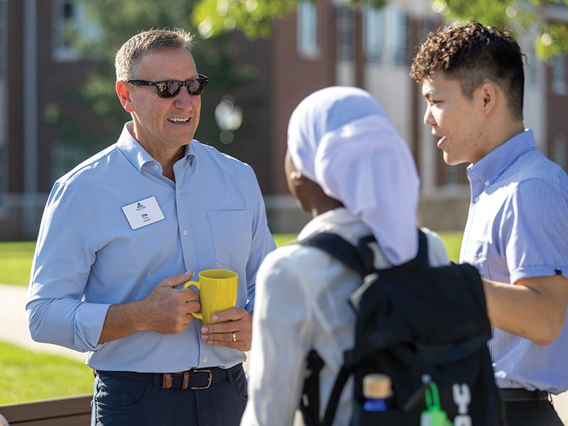 photo of president troha with coffee on the quad attendees