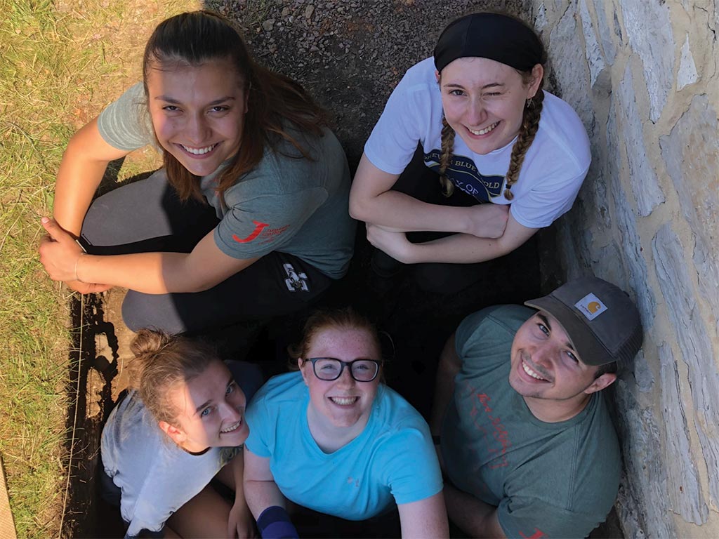 group of students posing for a photo at the dig site