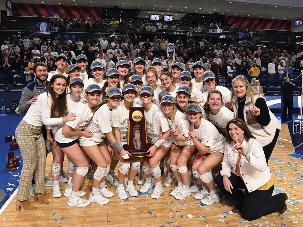 Photo by JD Cavrich Juniata College’s Women’s Volleyball Team and their coaches pose with the NCAA Division III National Championship trophy.