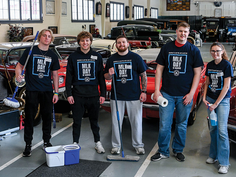 A group of students volunteered to clean at the Swigart Antique Auto Museum.