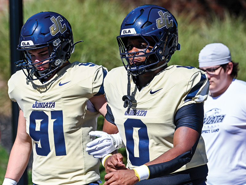 Juniata football players walk to the field