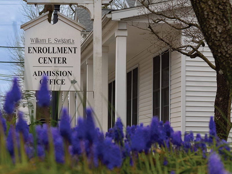 photo of spring flowers blooming in front of Juniata College's enrollment center