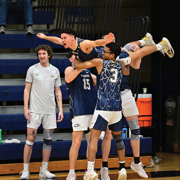 photo of mens volleyball team celebrating