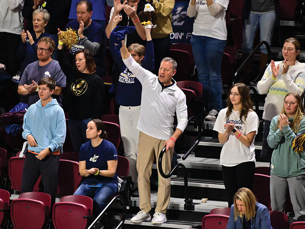 photo of president Troha in the stands cheering at a sporting event